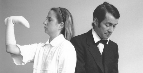 Black and white photo of two characters from
