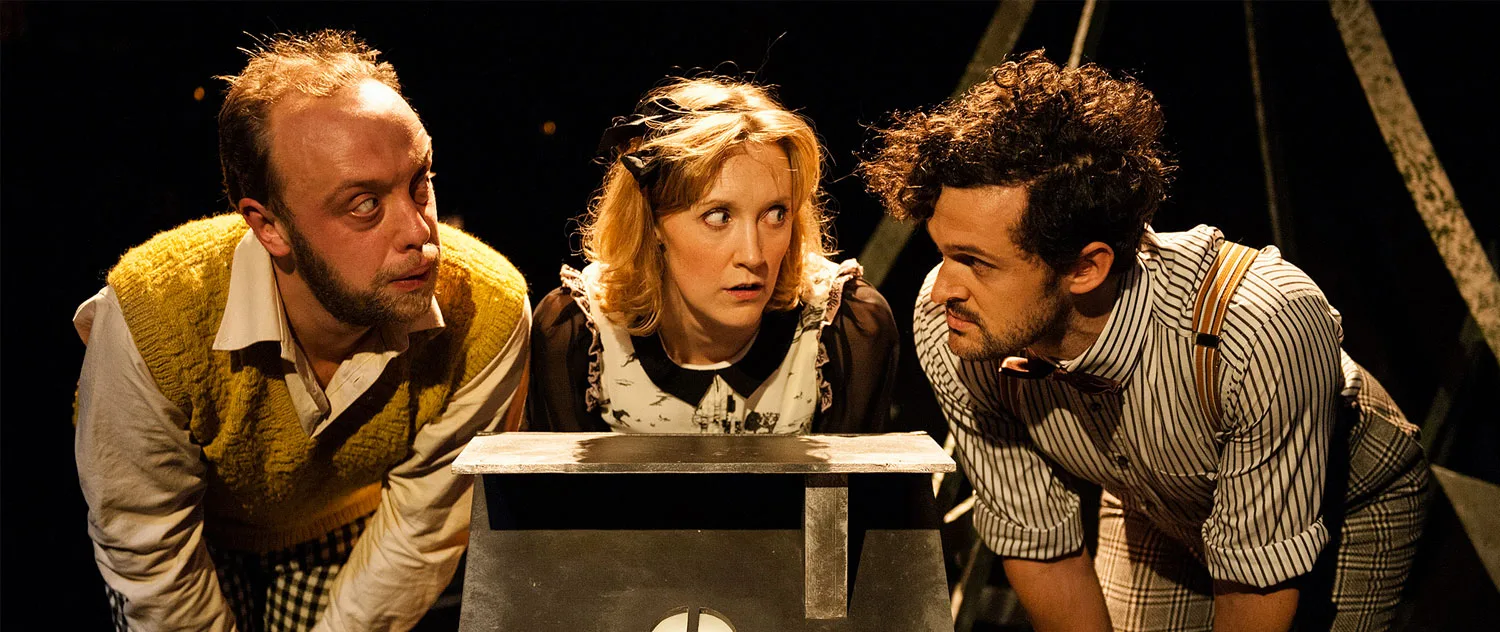 2 men and 1 woman looking at each other confused.