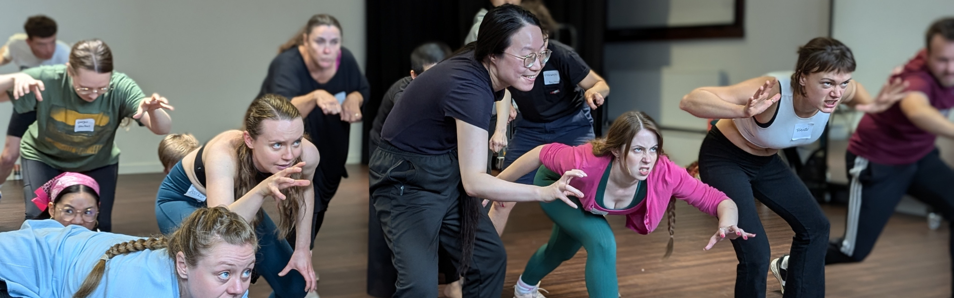 A group of people at various standing postitions in a studio.